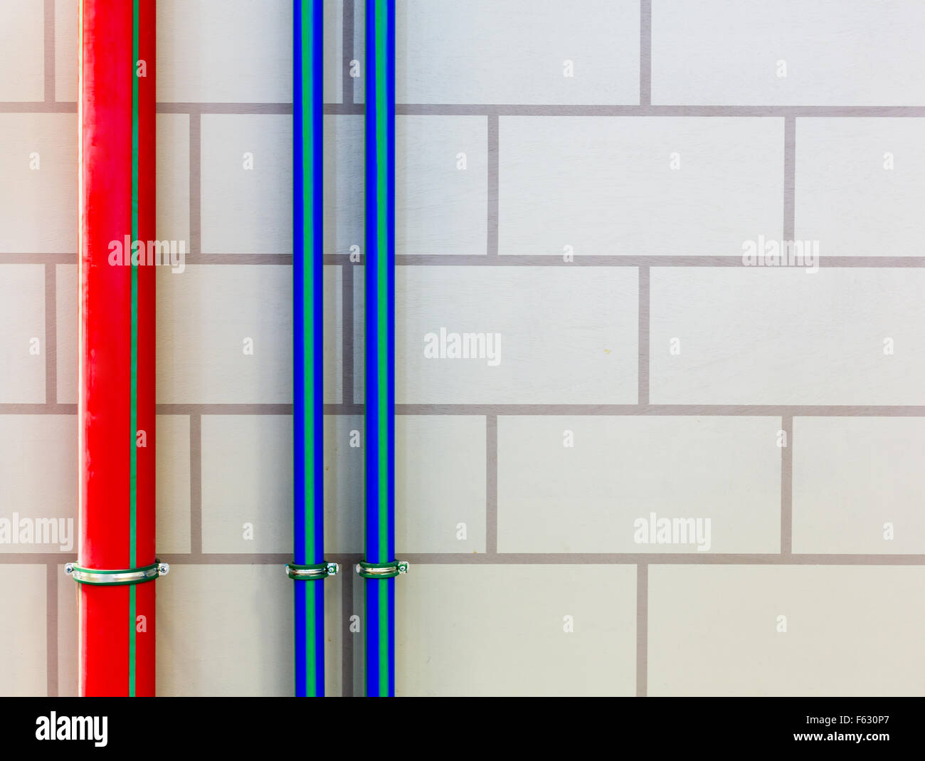 Red and blue water pipes on the wall Stock Photo Alamy