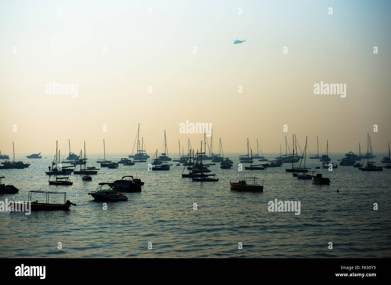 Fishing and tourist boats at the Arabian sea by the Taj Mahal palace hotel in Mumbai. Stock Photo