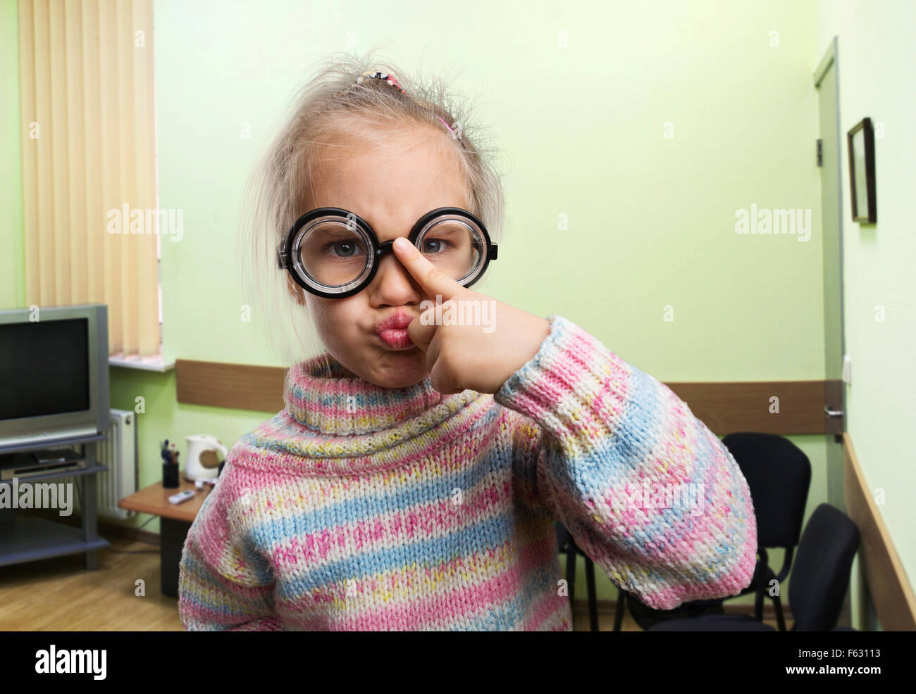 Egghead little girl in nerd glasses in the class Stock Photo