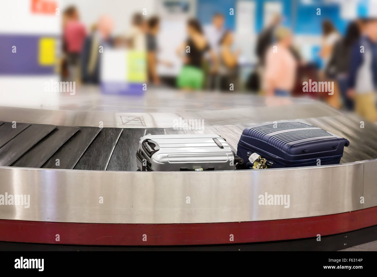 Two suitcases on the luggage belt in the airport hall Stock Photo