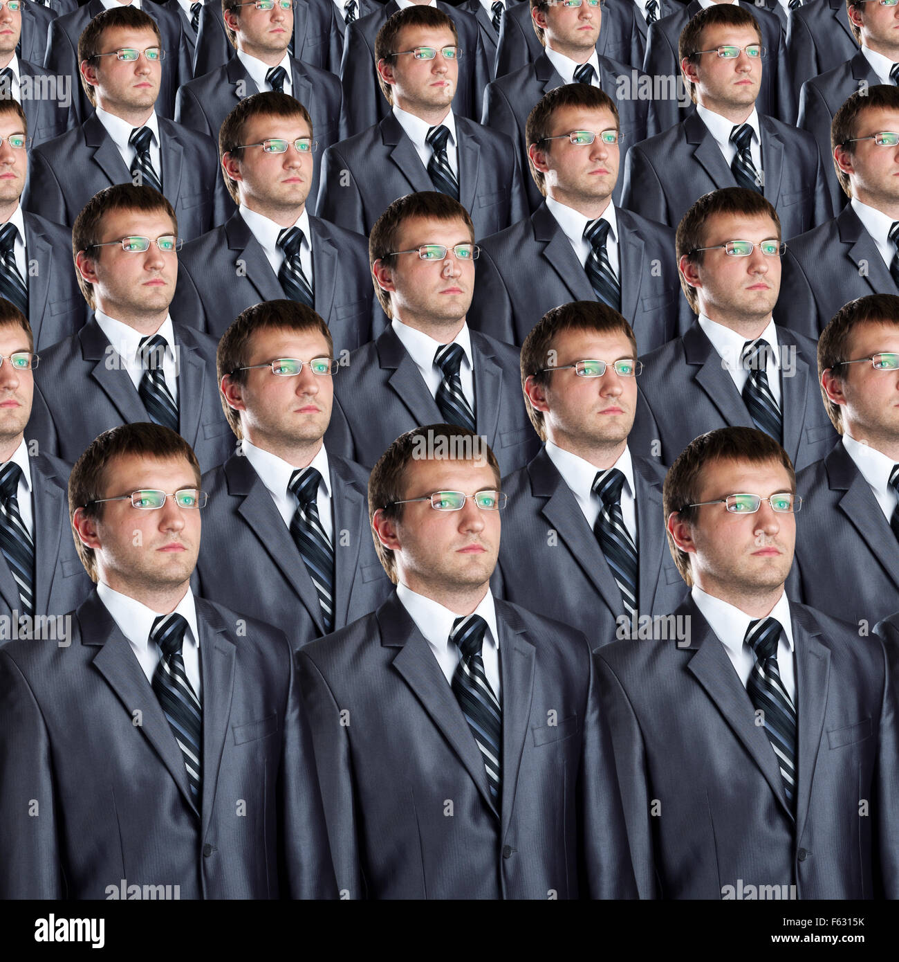 Many identical businessmen clones. Businessman production concept Stock Photo