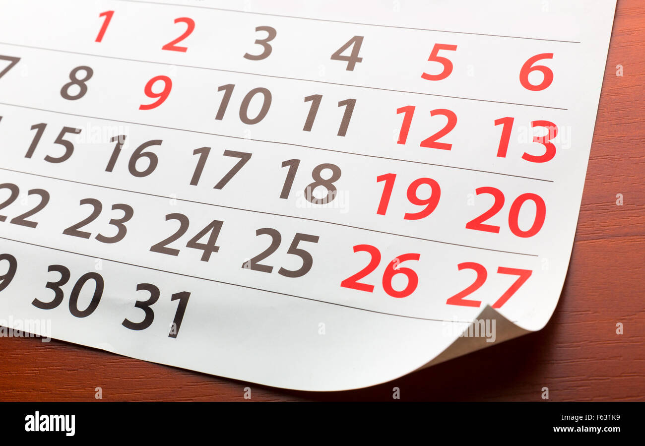 Closeup of a page from calendar lays on the wooden table Stock Photo