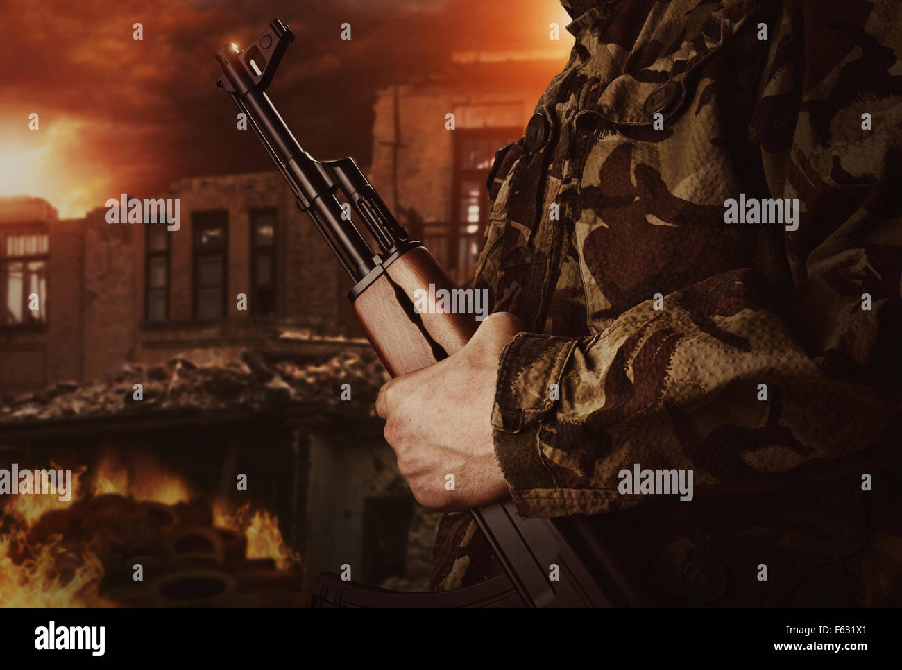 Soldier is holding gun on apocalyptic dark background Stock Photo
