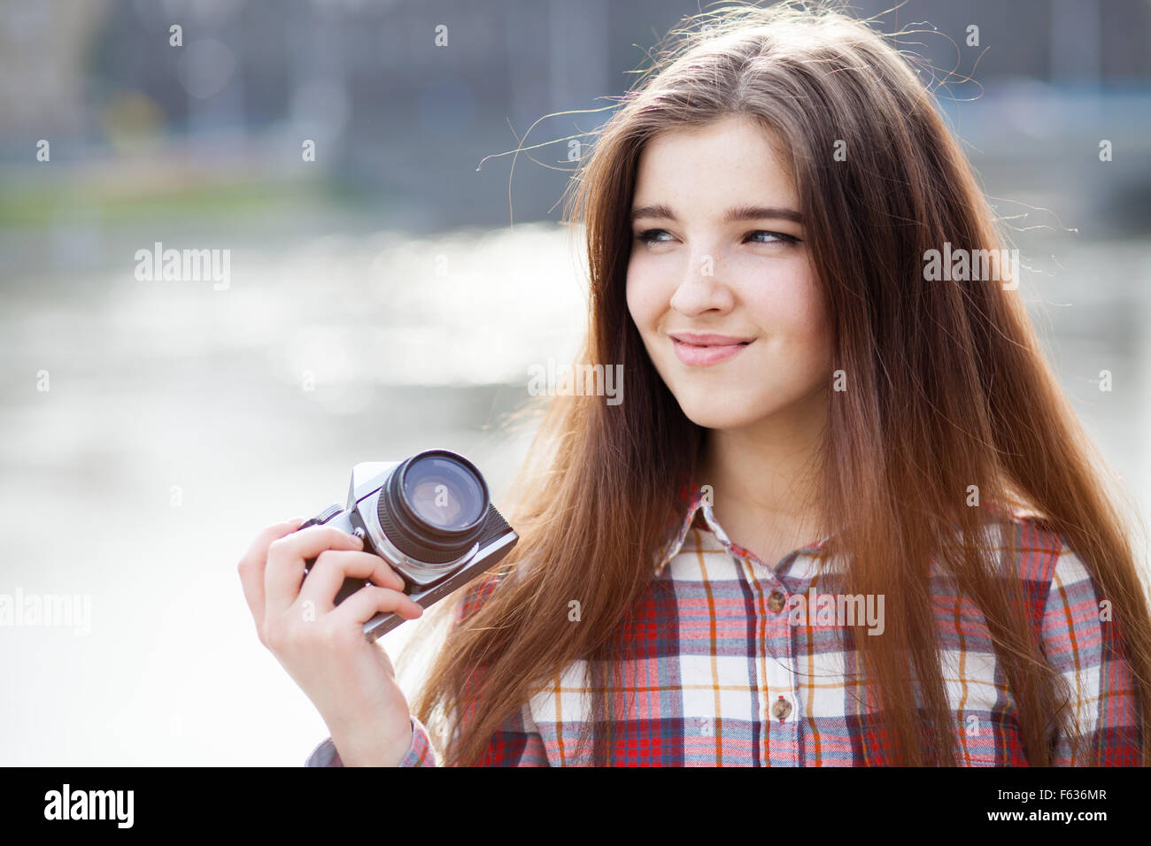 Portrait of a young woman with photo camera Stock Photo