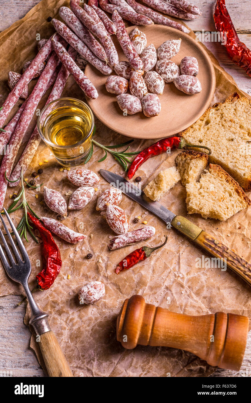 Different kinds of italian salami on rumpled paper Stock Photo Alamy