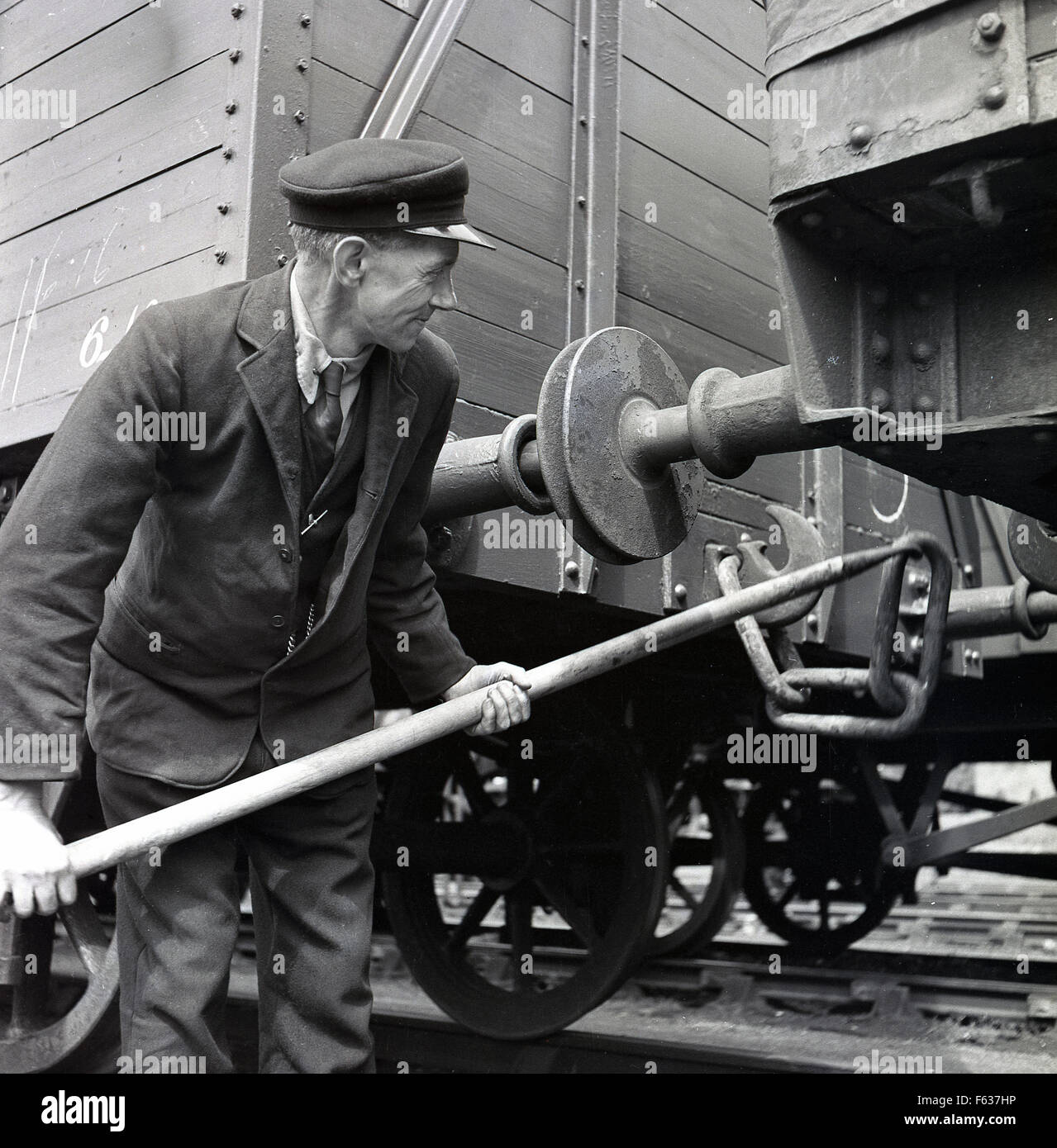 1950s historical picture, railway guard coupling or shunting, connecting rolling  stock or freight wagons by using special equipment known as draft gear,  Acton, London, England, UK Stock Photo - Alamy