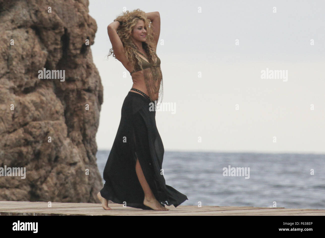 Shakira films a commercial in Tossa de Mar, Spain. The singer wears a  bikini top and a skirt with slits and is seen playing with her eldest son  Milan while taking a