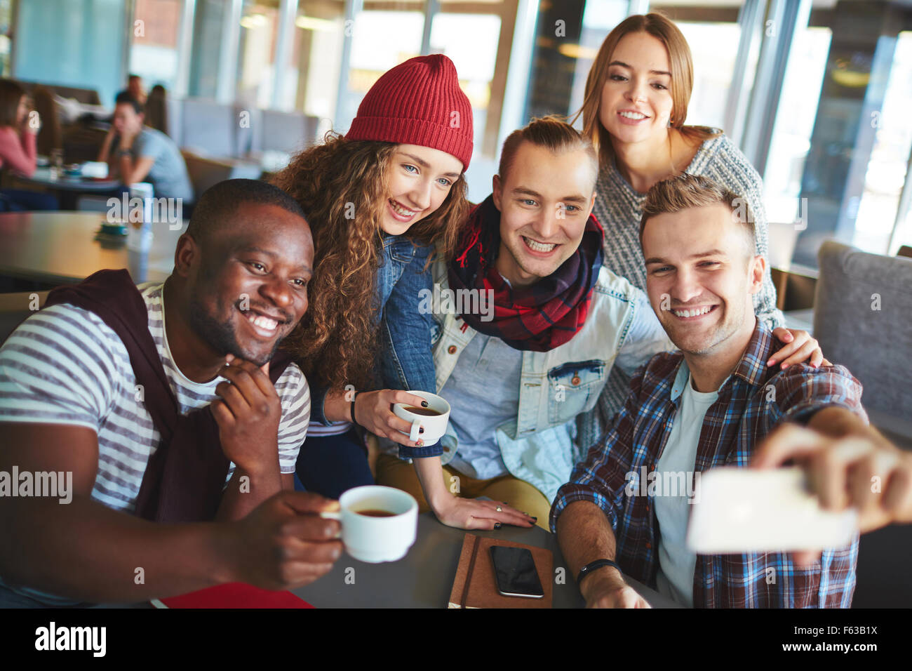 Friendly teenagers making selfie in cafe Stock Photo