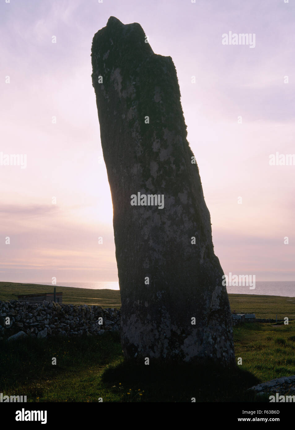 At 5.75m(19ft) high, Clach an Trushal (Thrushel Stone) on NW coast of Isle of Lewis is one of the most impressive standing stones in Scotland. Stock Photo