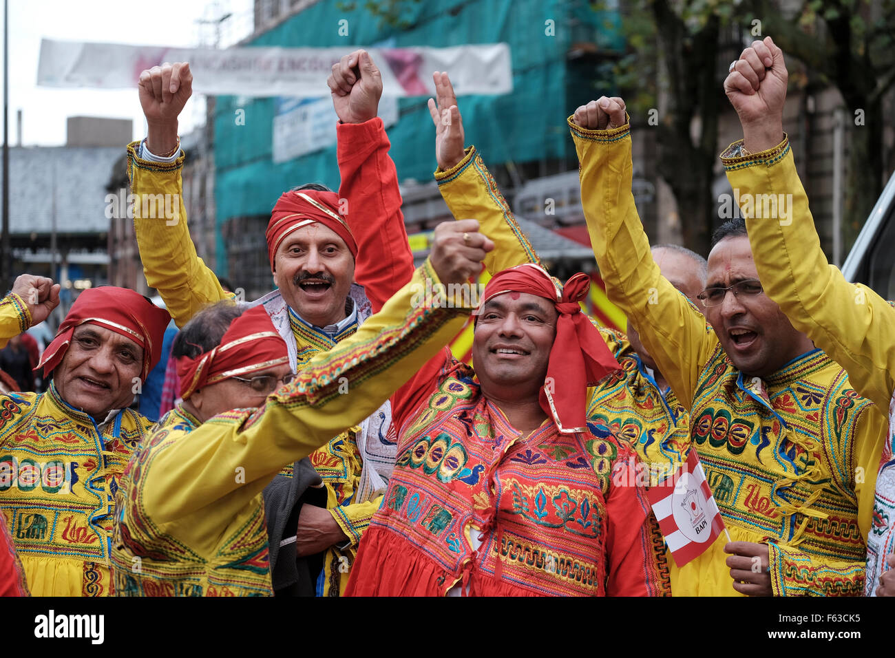 Hindu men dressed in colorful, traditional costumes for a ceremony in Preston UK Stock Photo