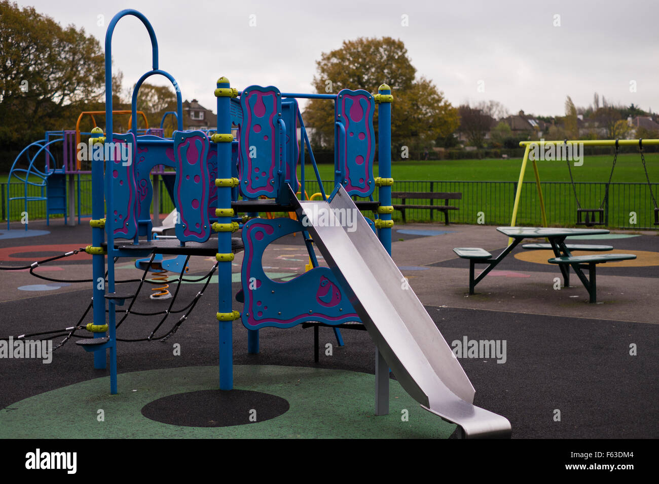 empty children play area in park in Autmn Croydon Surrey UK Stock Photo