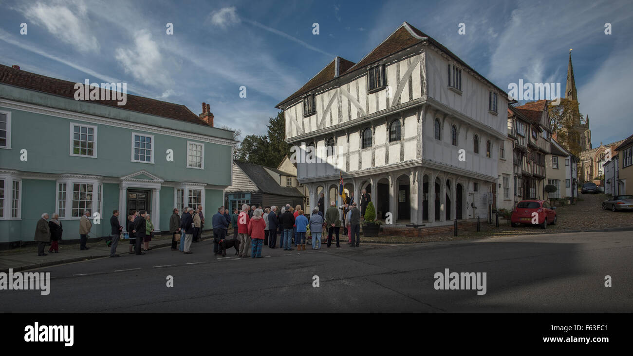 Thaxted, Essex, UK. 11th November 2015. On the steps of the 14th century Guildhall and with Thaxted Church at the top of Stoney Lane in Thaxted at the 11th hour on the 11th day of the 11th month when the guns fell silent after four years of way in 1914-1918 men and women and a few children from the small medieval town of Thaxted stand for a two minute silence to remember those who have given there lives for their country that we may go old. Credit:  BRIAN HARRIS/Alamy Live News Stock Photo