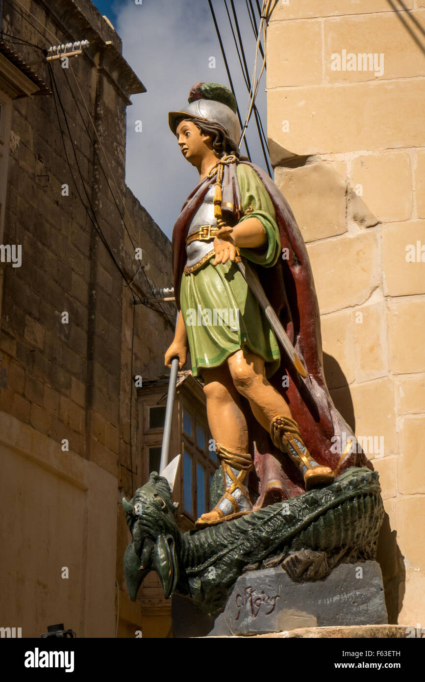 Statue of St George slaying the dragon on a street corner in Victoria, or Rabat, the capital city of Gozo, Malta. Stock Photo