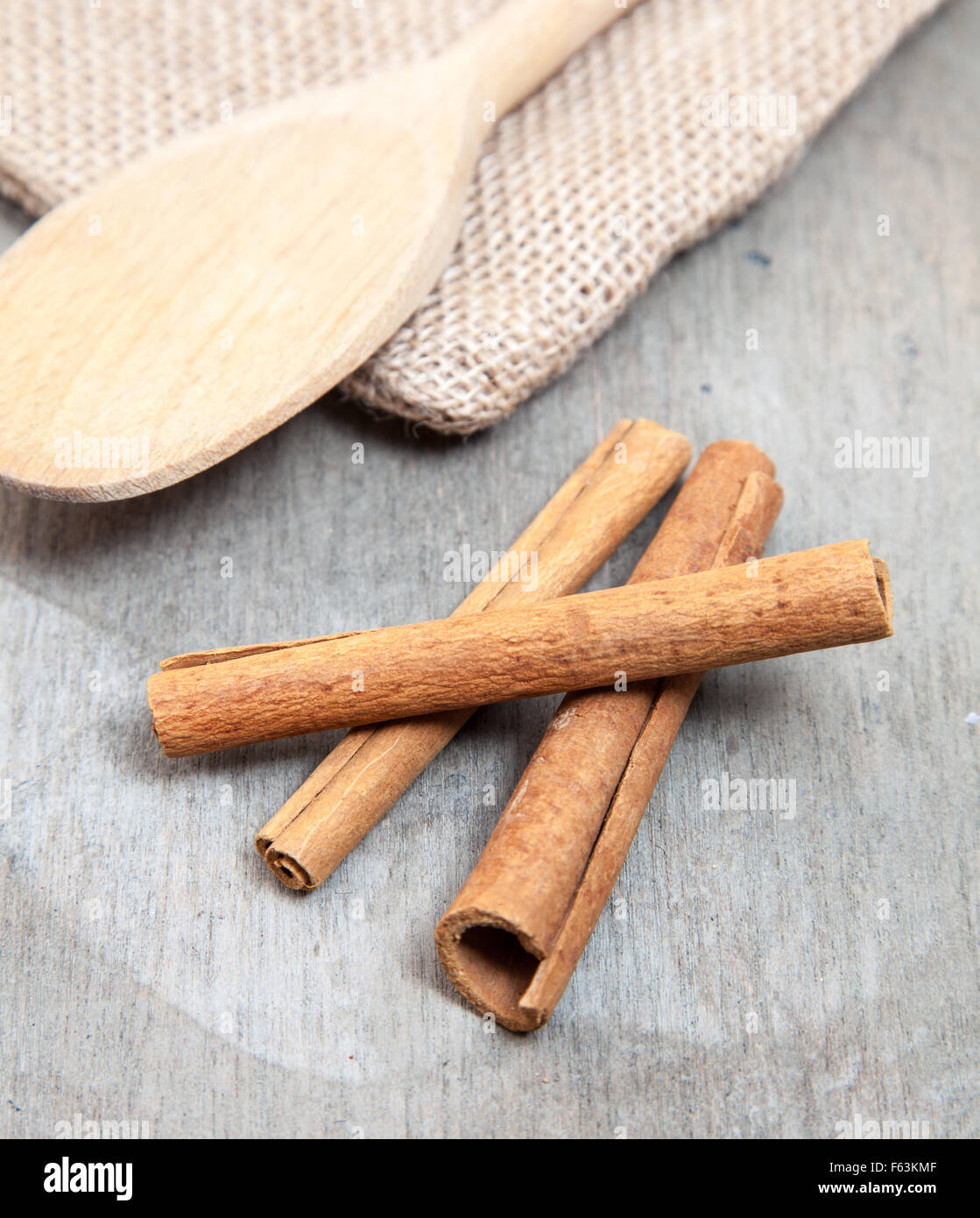 Fine cinnamon sticks on wooden background Stock Photo