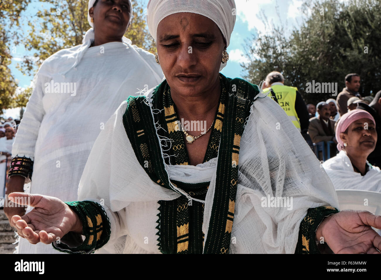 Jerusalem, Israel. 11th Nov, 2015. Jewish Ethiopian women wave their hands and bow in prayers of thanksgiving for delivery to Israel. The Jewish Ethiopian community in Israel, Beta-Israel, celebrated the Sigd, symbolizing their yearning for Jerusalem for thousands of years of exile, at the Haas Promenade overlooking the Temple Mount. Credit:  Nir Alon/Alamy Live News Stock Photo