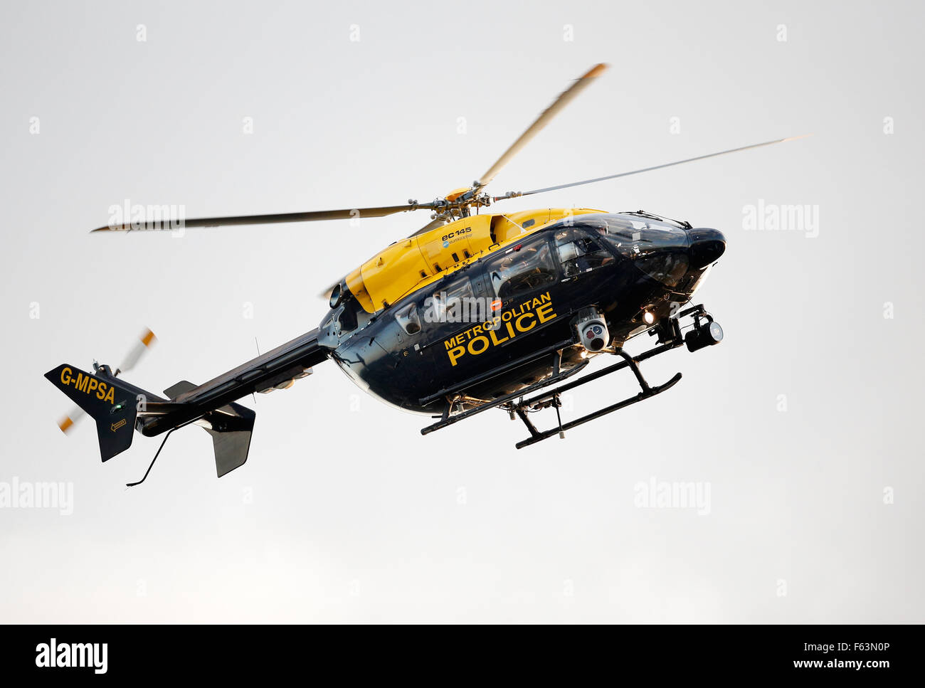 A Metropolitan Police helicopter flies over London to observe crowd movement during a major sports event in the capital. Stock Photo