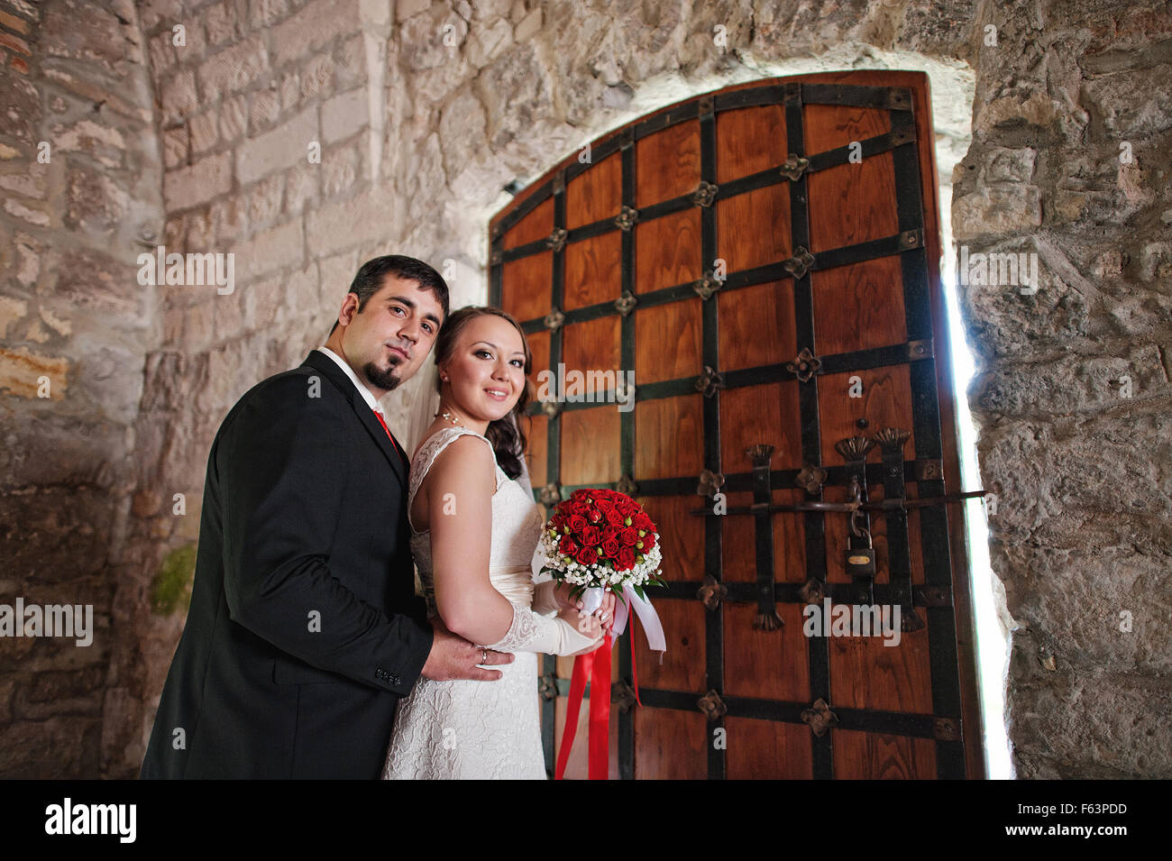 wedding couple in the castle near the old gate Stock Photo - Alamy