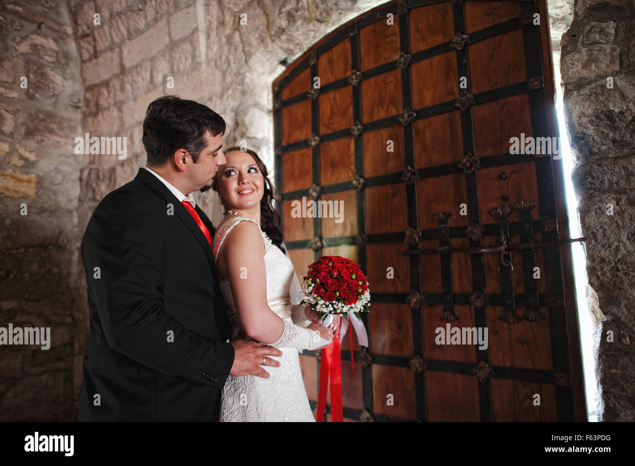 wedding couple in the castle near the old gate Stock Photo - Alamy