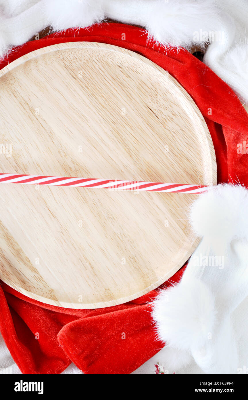 Wooden plate with red straw on Christmas concept background Stock Photo