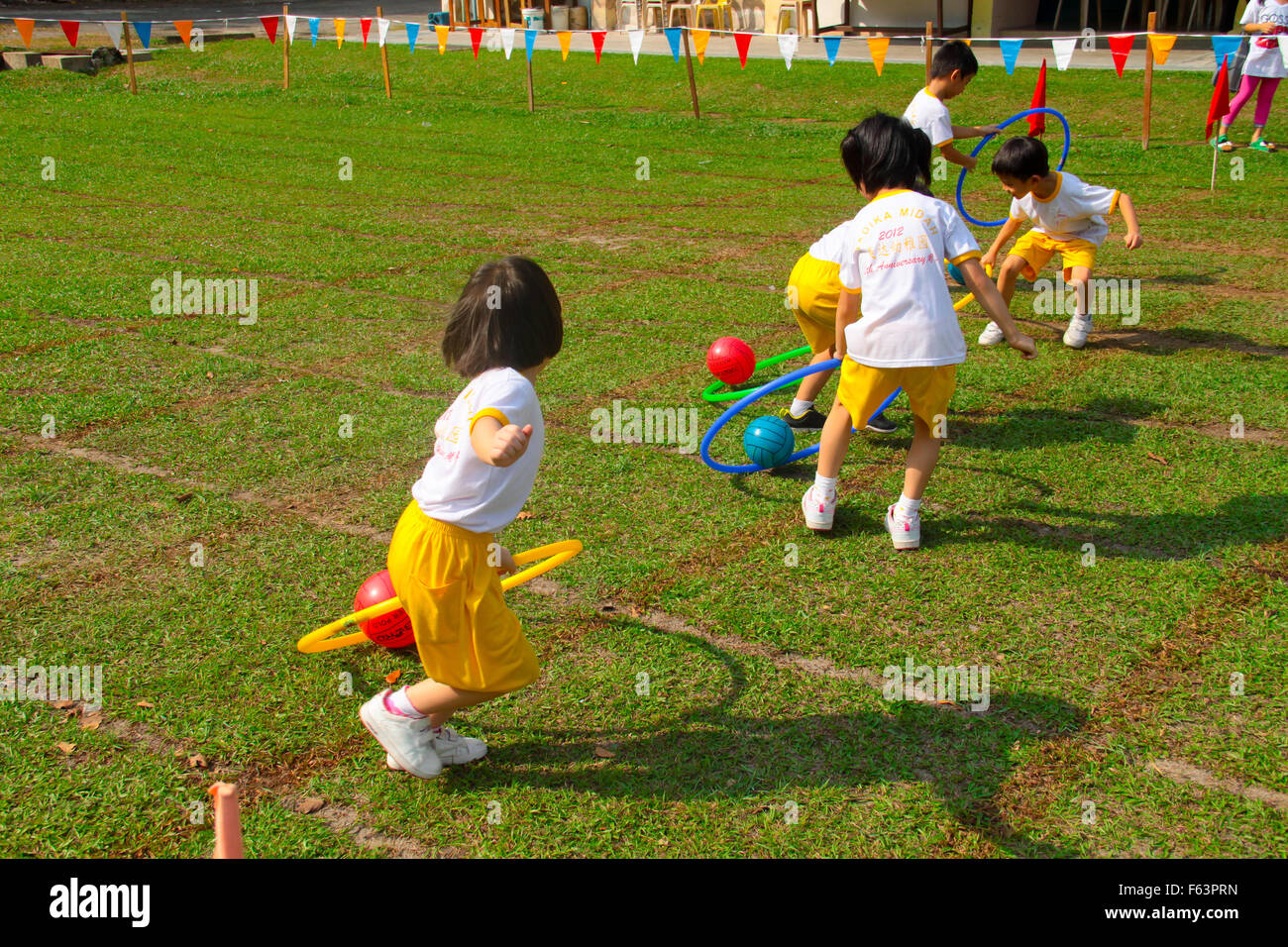 Kindergarten children competing in drag the ball race during their sport  day Stock Photo - Alamy