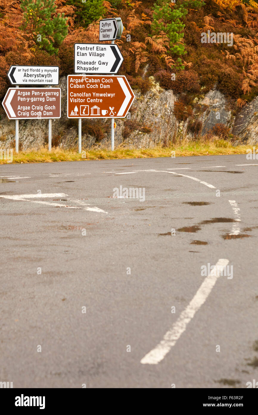 Roadsigns on junction at Garreg Ddu Dam, Elan Valley, Powys, Mid Wales, UK in November with Autumn foliage colours Stock Photo