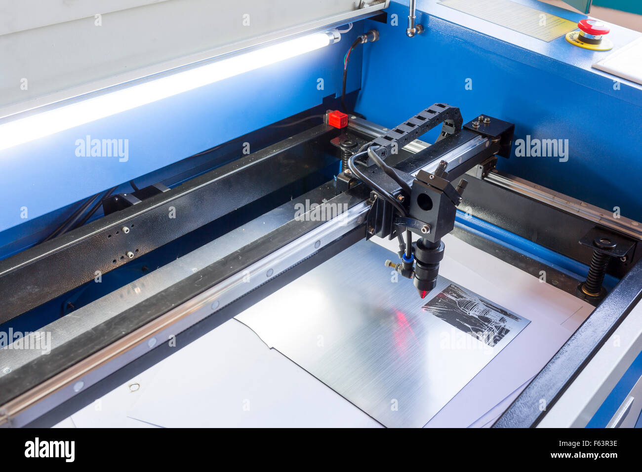 Laser machine is cutting an image on a flat sheet ot steel in a