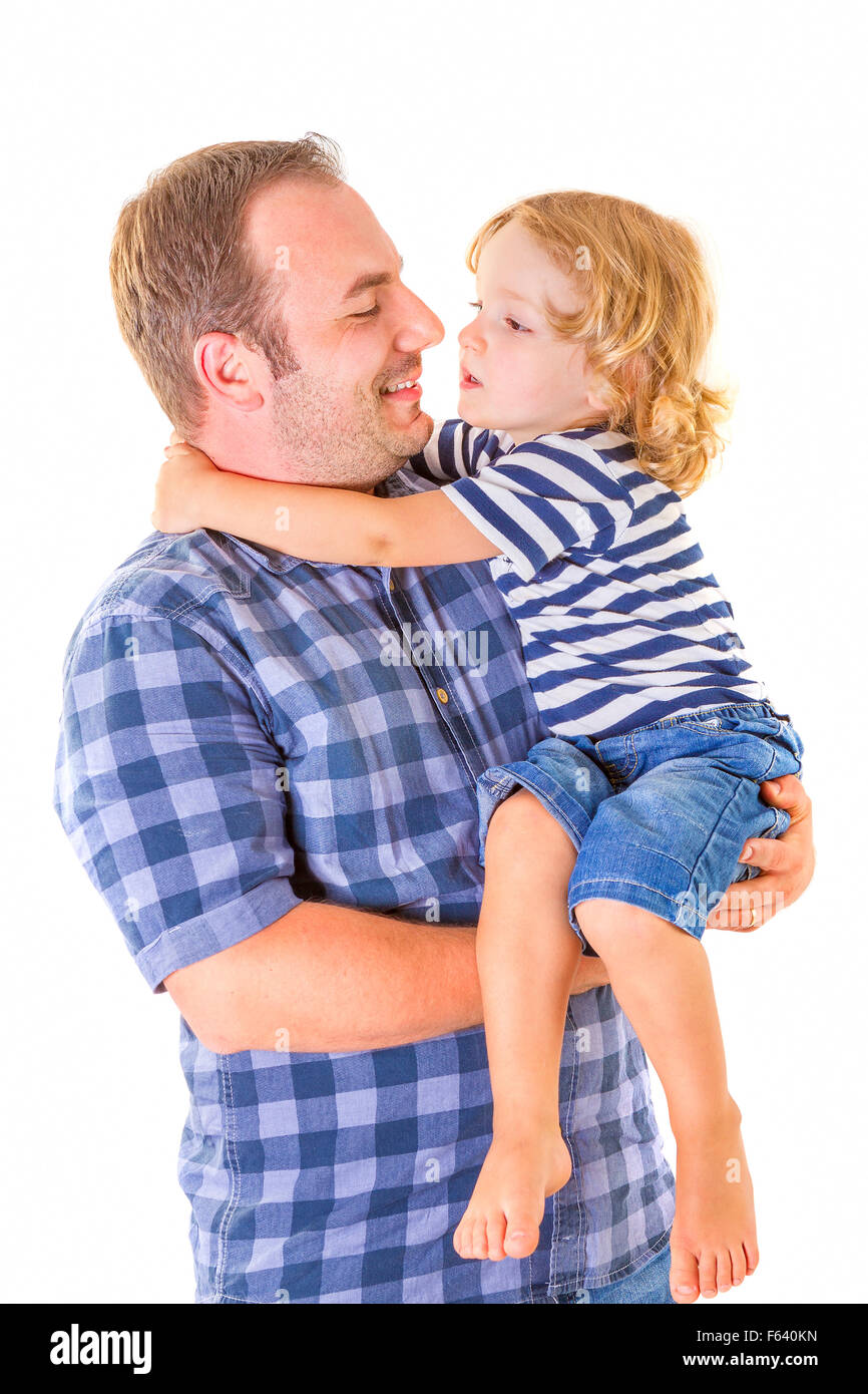 Portrait of young attractive smiling father playing with his little cute son on white background. Stock Photo