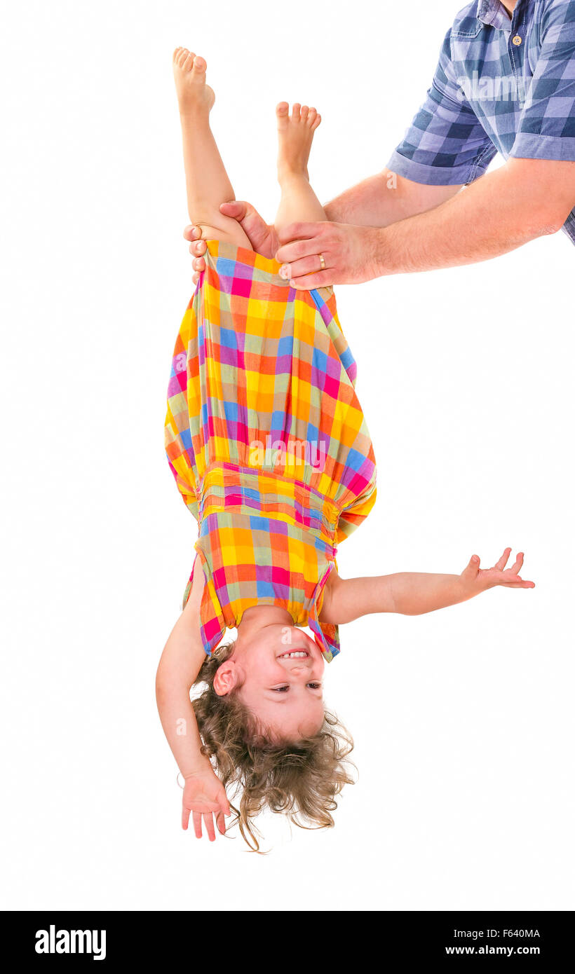 Father holding his little daughter upside down. Trust concept. Stock Photo