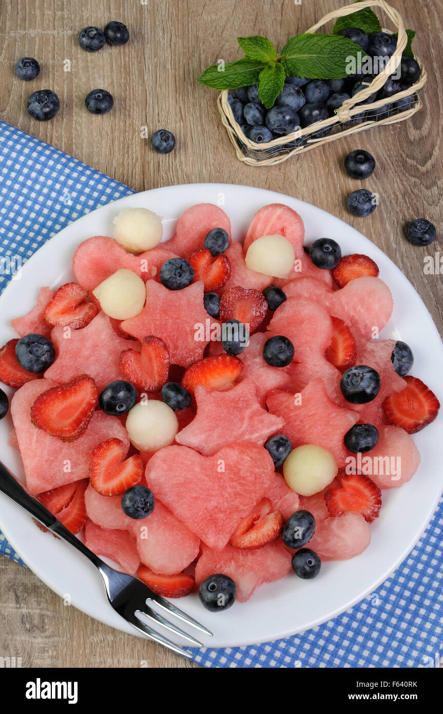 salad of blueberries, watermelon hearts, stars, balls of melon and strawberries Stock Photo