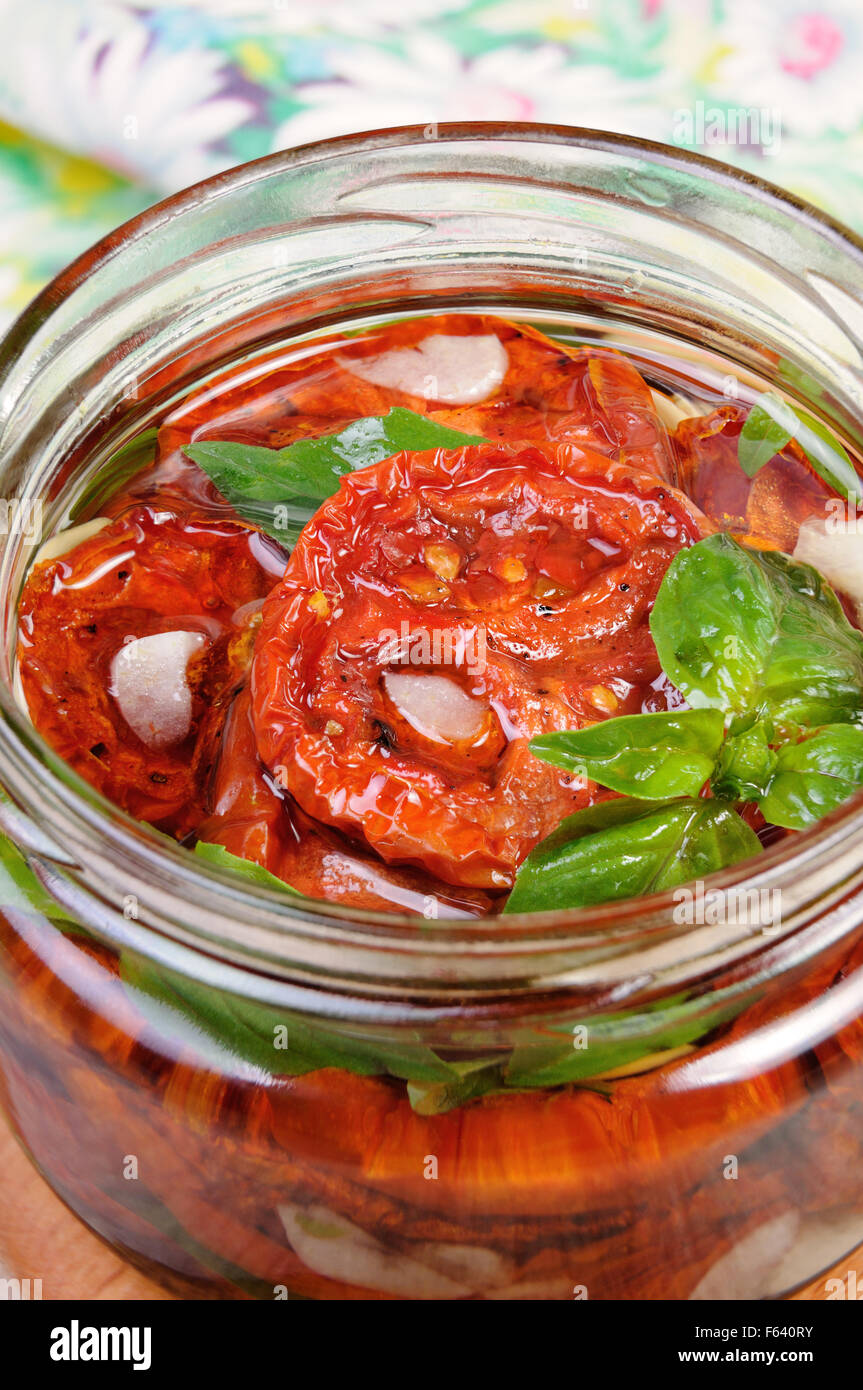 Slices of dried tomatoes with garlic and basil oil Stock Photo - Alamy