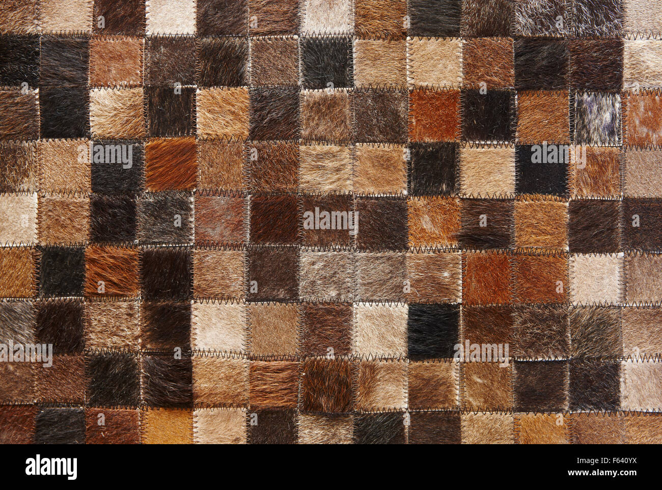 Needlework background of skin squares with animal hair Stock Photo