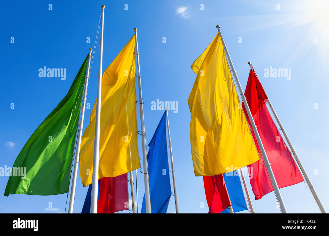 Colorful flags fluttering on the blue sky background Stock Photo - Alamy