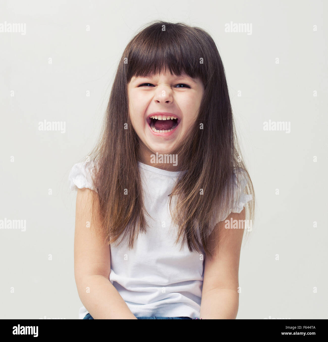 Cute little girl smiling studio portrait Stock Photo - Alamy