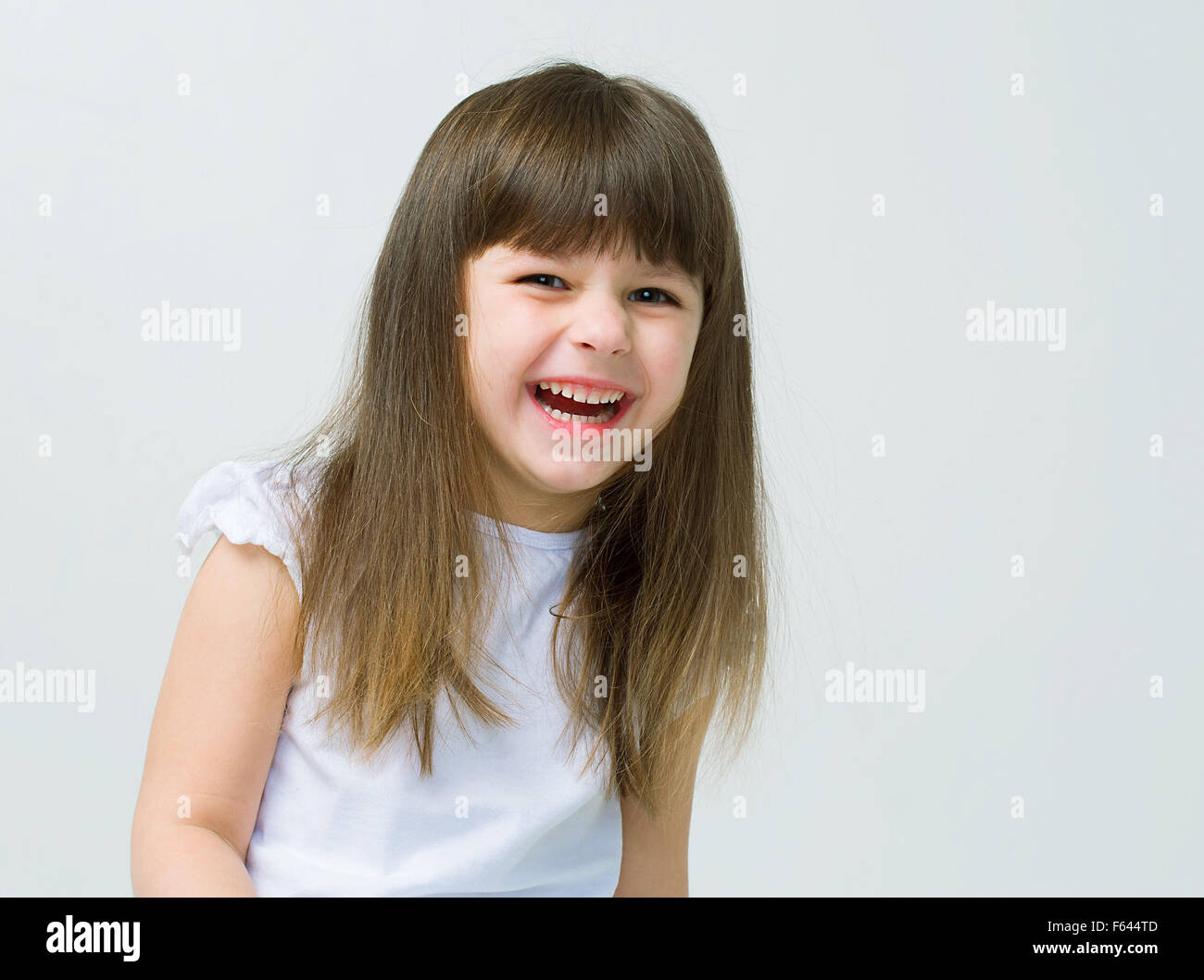 Cute little girl smiling studio portrait Stock Photo - Alamy