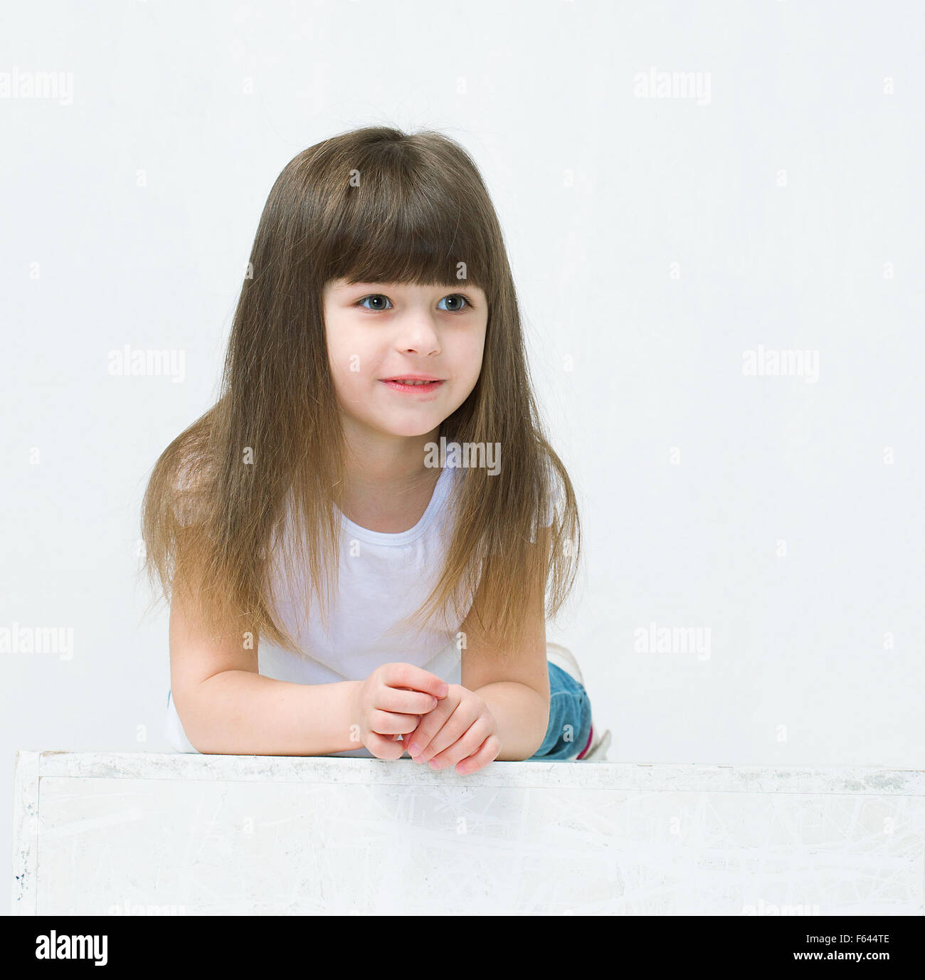 Cute little girl smiling studio portrait Stock Photo - Alamy