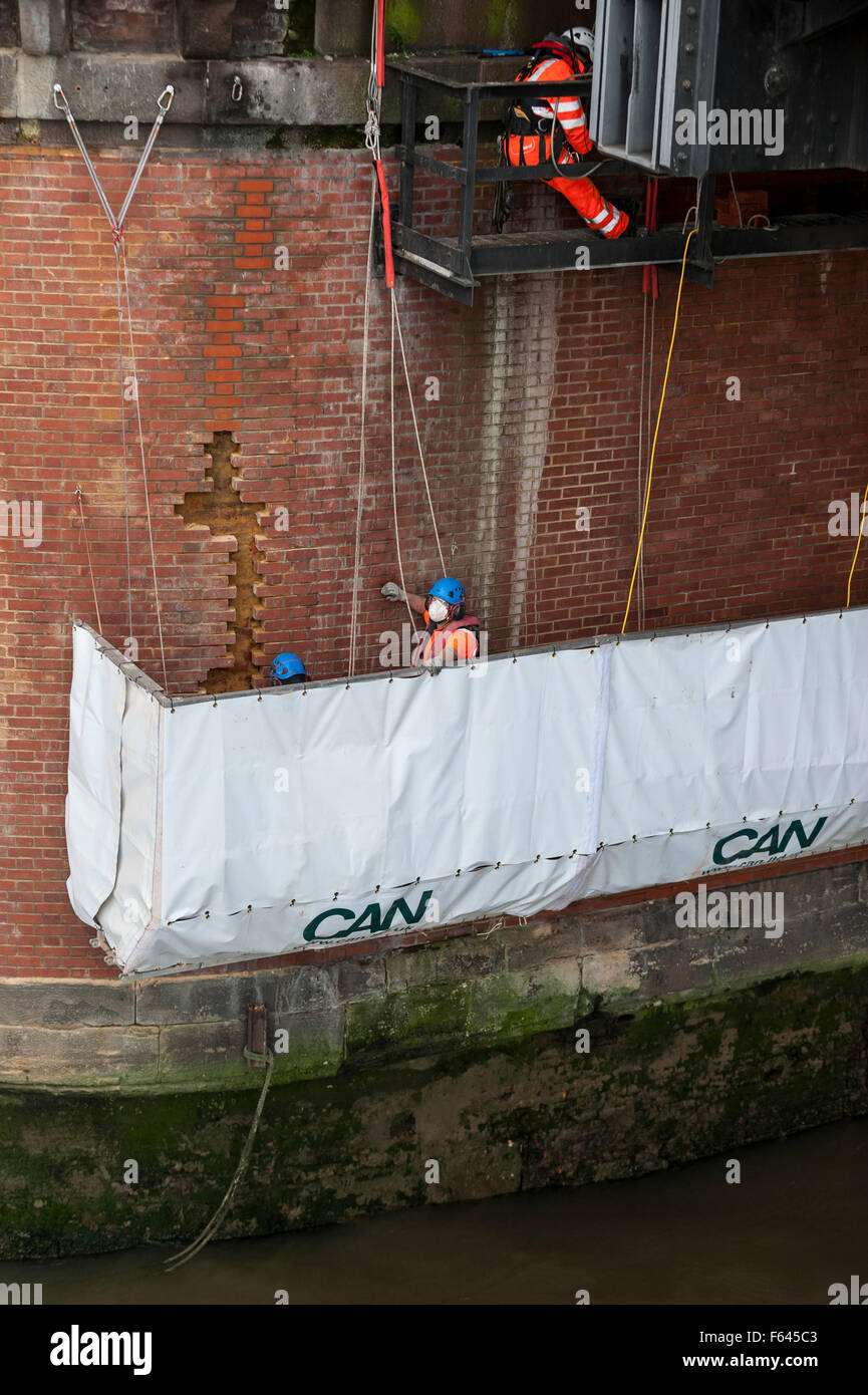 London, UK. 11 November 2015. Construction workers at work on one of