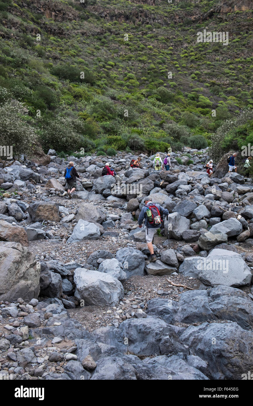 Crossing the boulder strewn bottom of a barranco in Tenerife, Canary Islands, Spain. Stock Photo