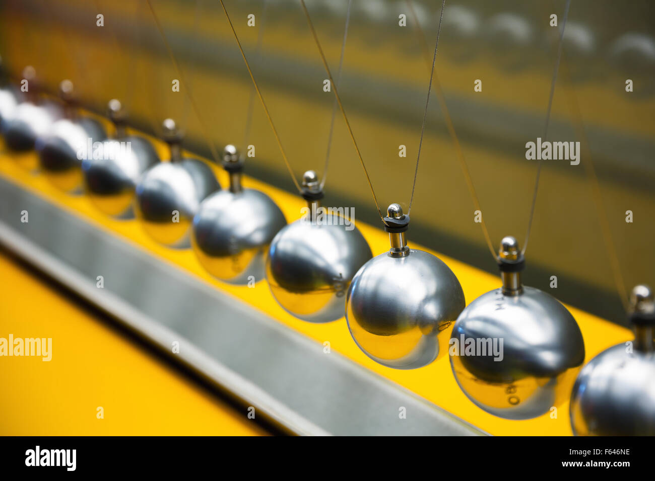 Newton's cradle balancing large group of balls Stock Photo Alamy