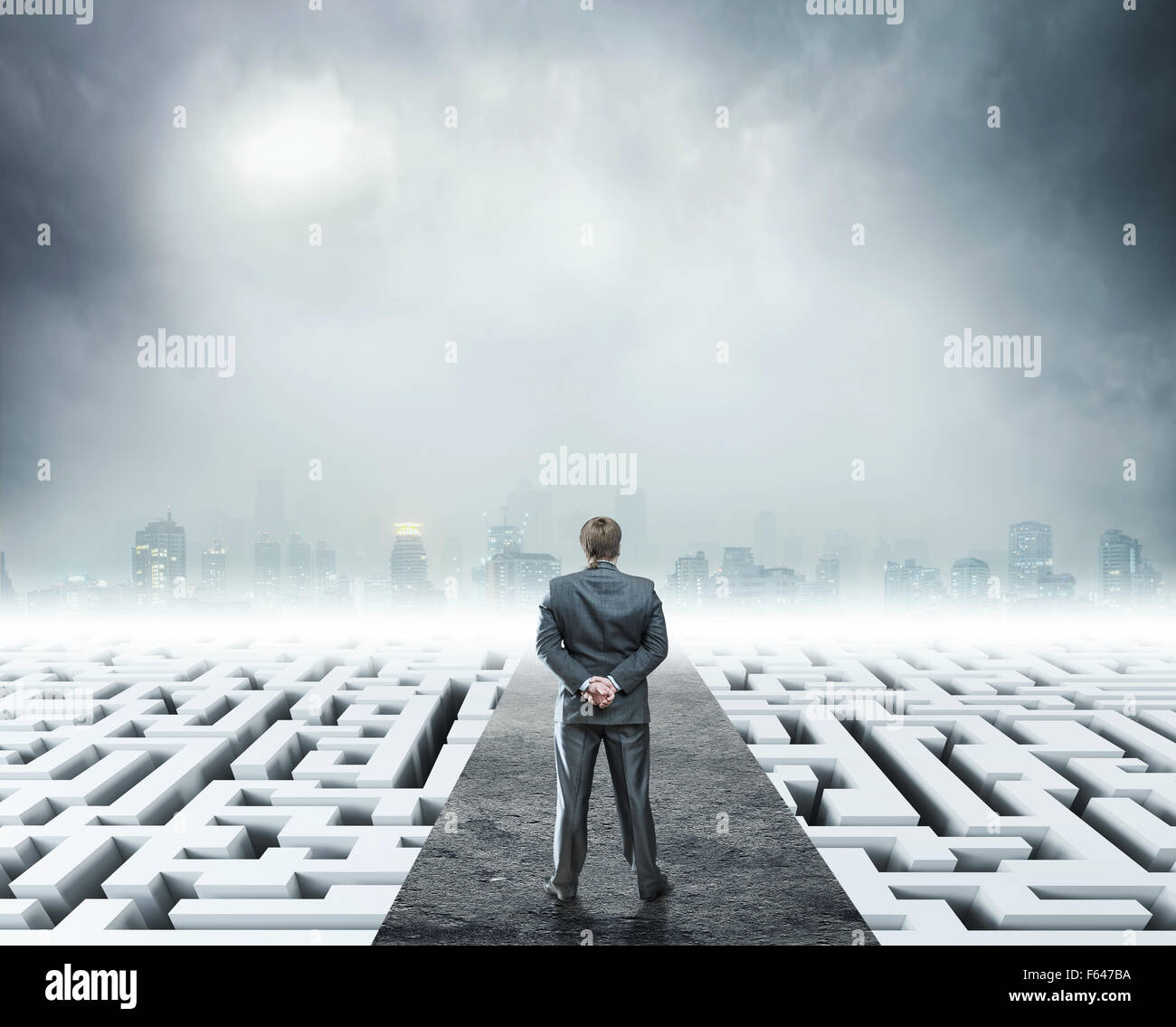 Businessman standing on labyrinth, metaphor for facing difficulties in business and the stress of daily life Stock Photo