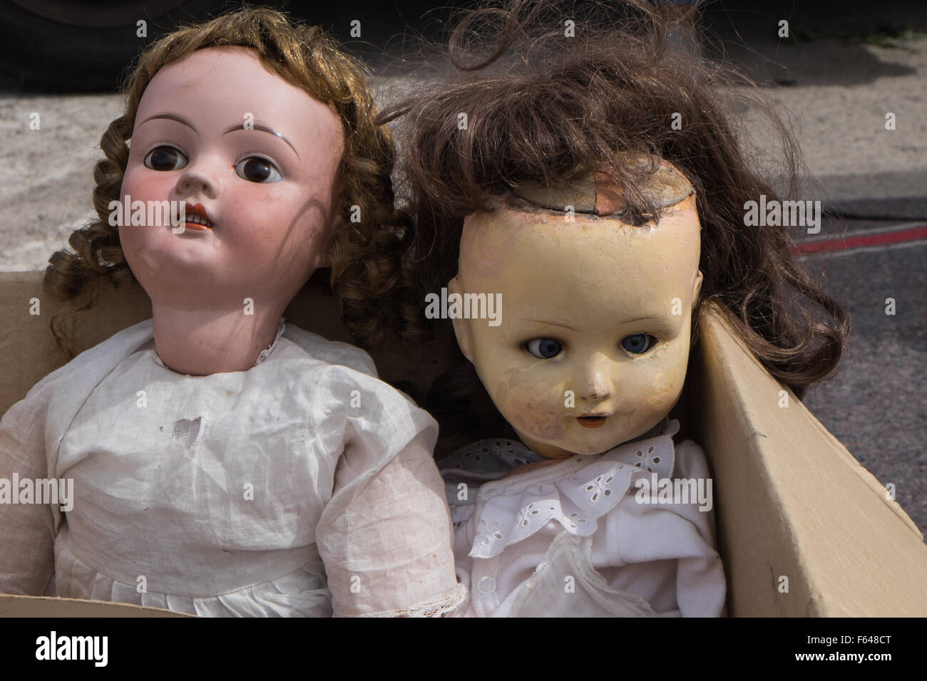 Antique dolls in a junk yard sale Stock Photo