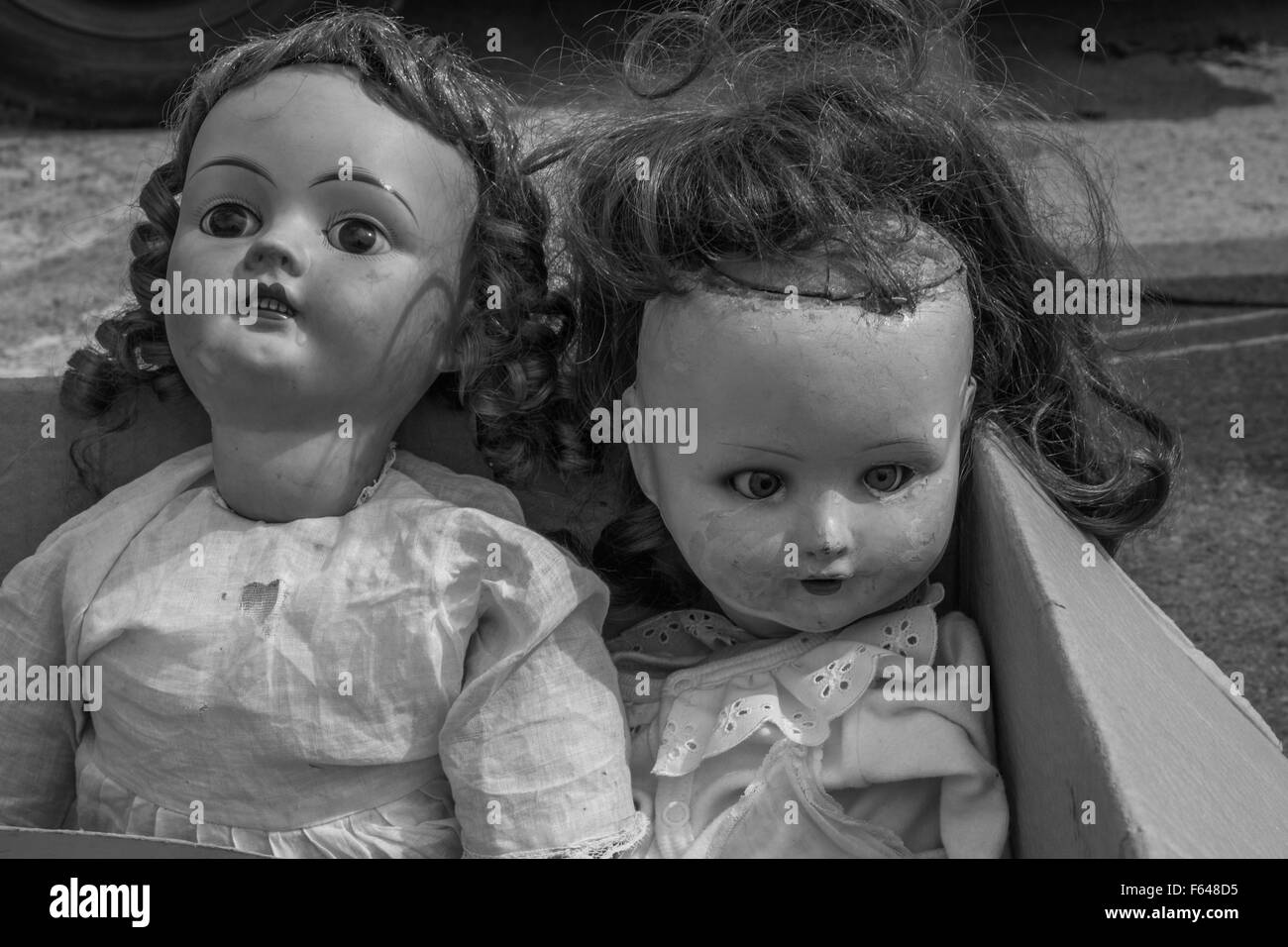 Antique dolls in a junk yard sale Stock Photo