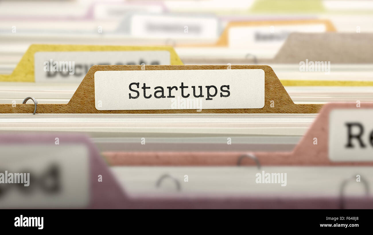 Startups Concept on Folder Register in Multicolor Card Index. Closeup View. Selective Focus. Stock Photo