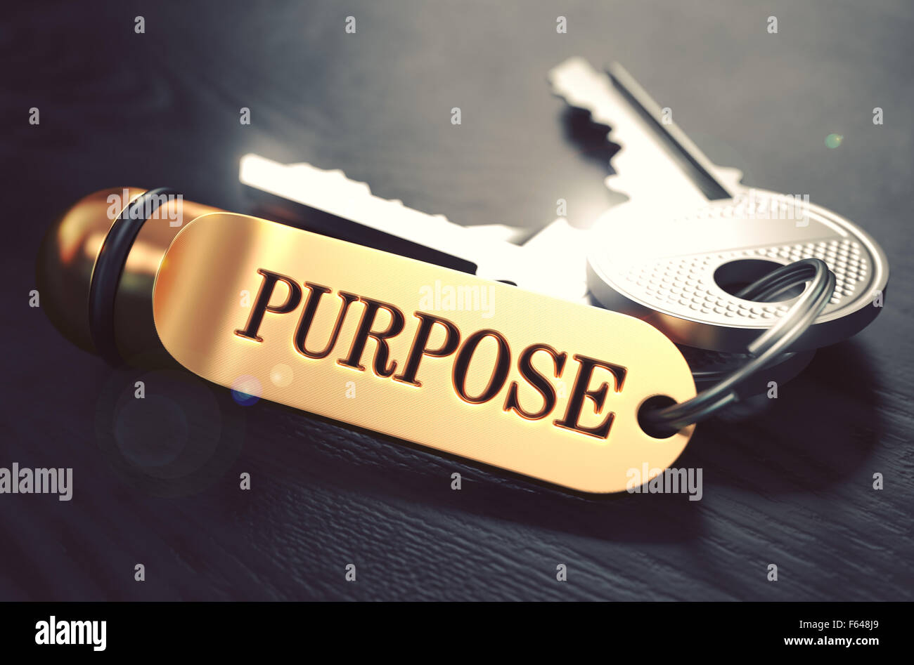 Purpose Bunch of Keys with Text on Golden Keychain. Black Wooden