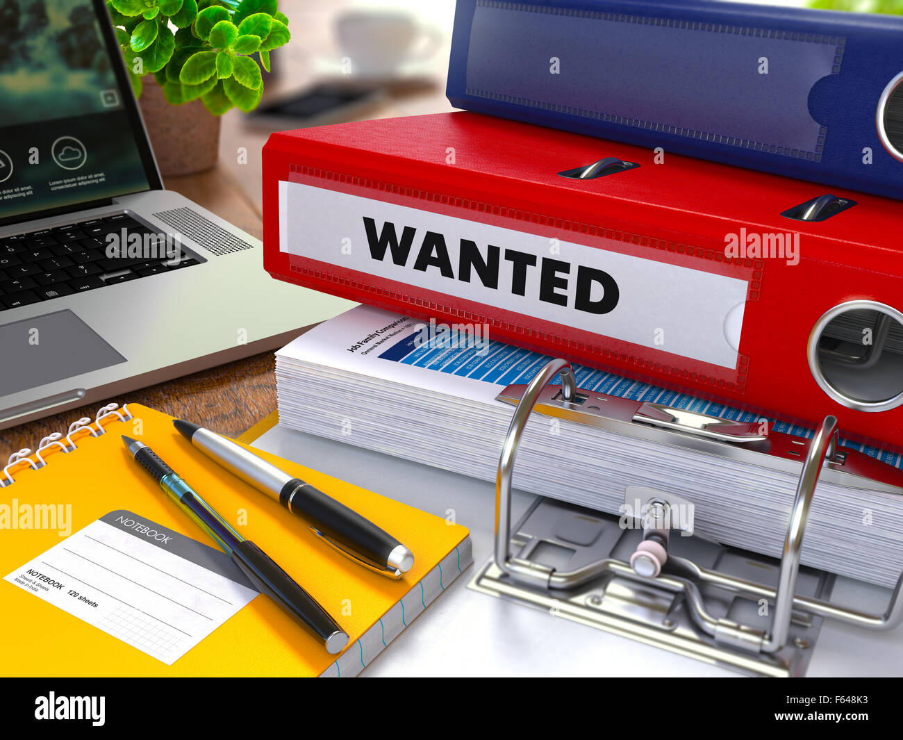 Red Ring Binder with Inscription Wanted on Background of Working Table with Office Supplies, Laptop, Reports. Toned Illustration Stock Photo