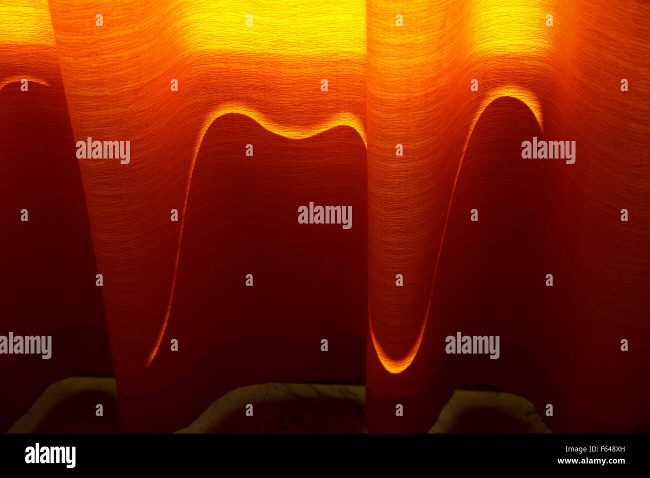 Orange Lazer Light Following Contours Of Curtains Dark Interiors