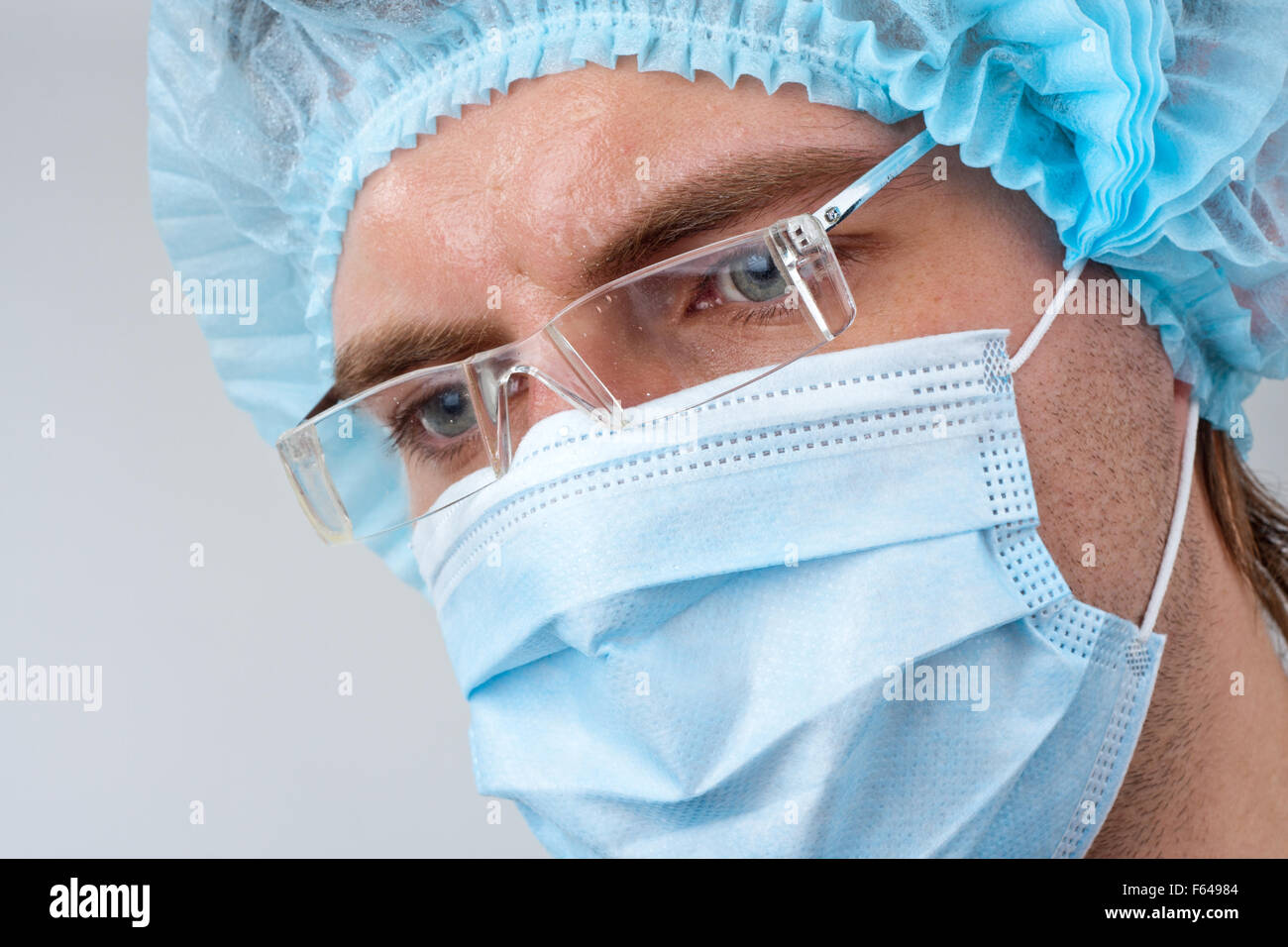 Portrait of sweat serious surgeon in surgical mask Stock Photo