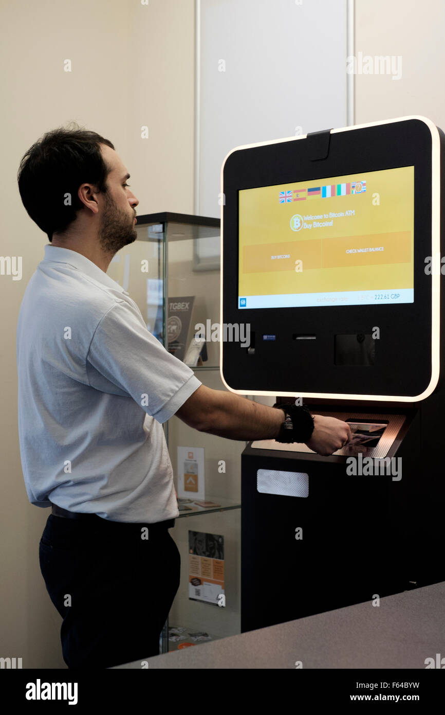 Young Male Using A Digital Currency Bitcoin Atm England Uk Stock - 