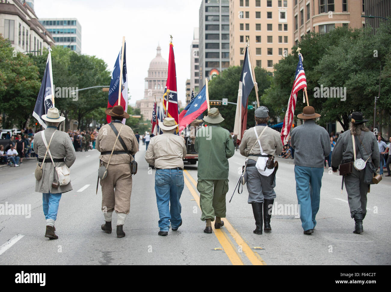 Austin, Texas USA November 11, 2015: Sons of Confederate Veterans display Civil War Confederate battle flags and the U.S. flag  during the Veteran's Day parade up Congress Avenue and ceremony at the Texas Capitol. Several thousand Texans lined Congress Avenue to witness military heroes, marching bands and floats in the annual parade. Credit:  Bob Daemmrich/Alamy Live News Stock Photo