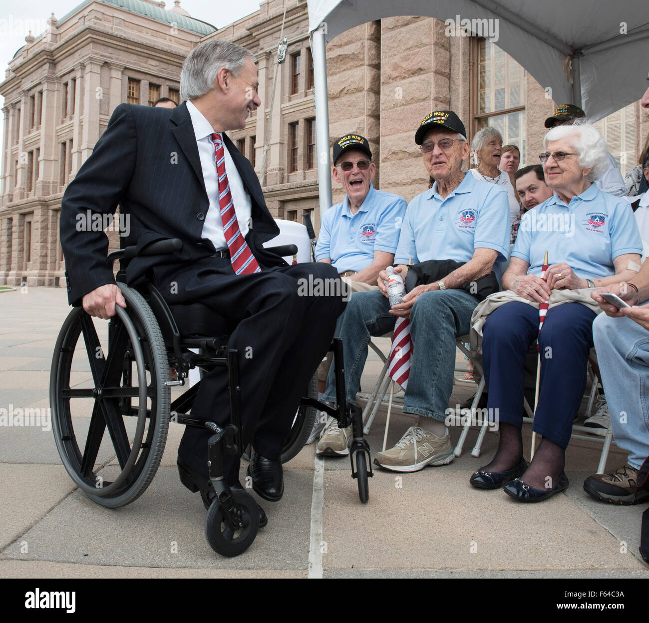 Austin, Texas USA November 11, 2015: Texas Gov. Greg Abbott (l) greets WWII veterans Gene Myers (Navy) and Eugene McClarq (Air Force) during the Veteran's Day parade up Congress Avenue and ceremony at the Texas Capitol. Several thousand Texans lined Congress Avenue to witness military heroes, marching bands and floats in the annual parade. Credit:  Bob Daemmrich/Alamy Live News Stock Photo