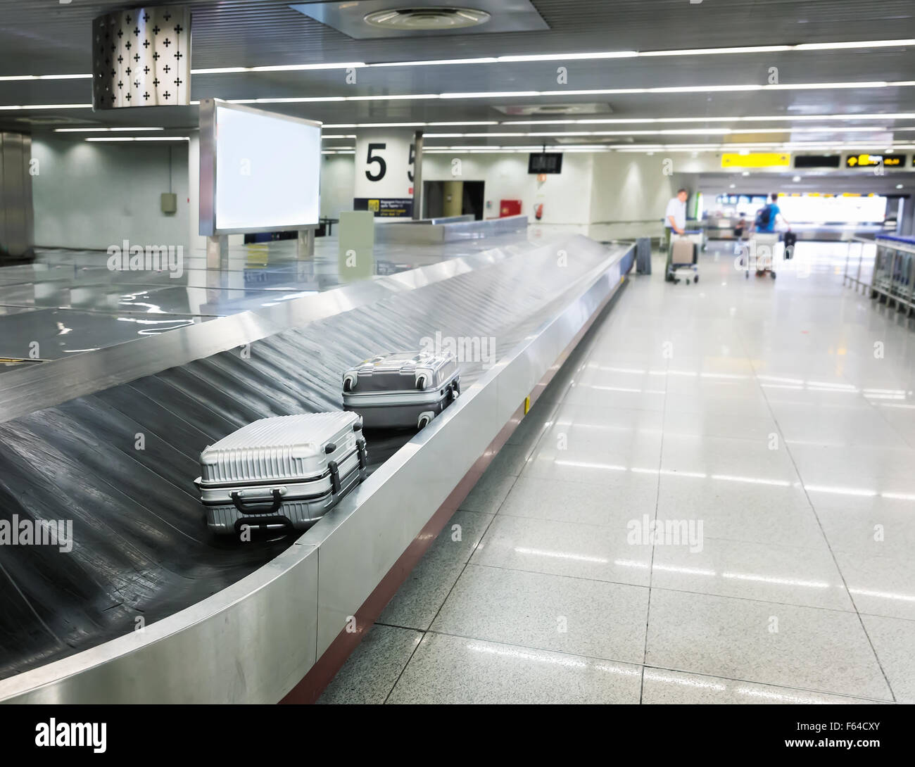 Two suitcases on the luggage belt in the airport hall Stock Photo